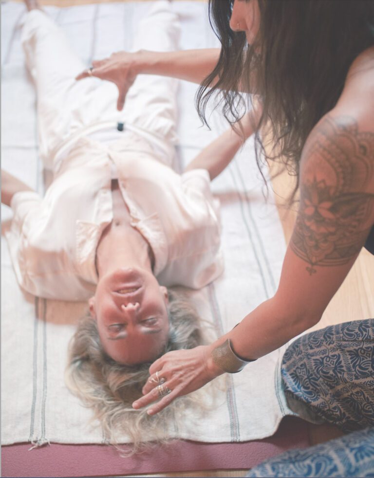 Bianca Be moving energy above client’s chest during kundalini activation as client arches body in response